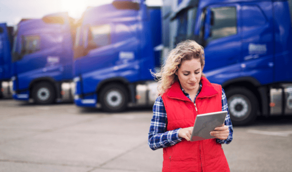 lady with red jacket near blue truck