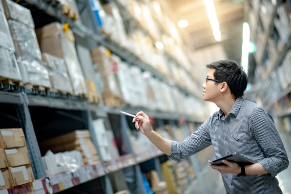 asian man taking stocktake product